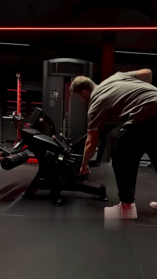 Real video frame: a user operates the adjustment beside the seat