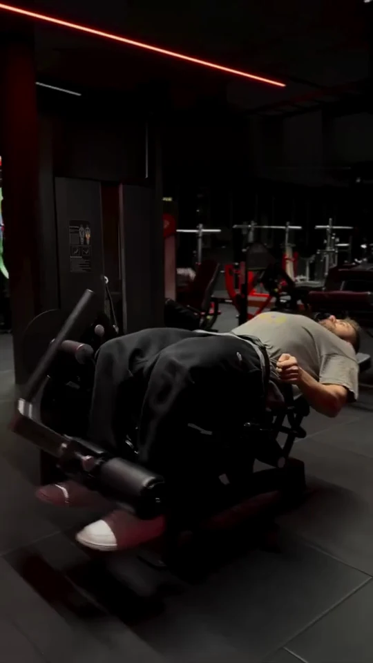 Real video frame: a user exercises with the backrest lowered